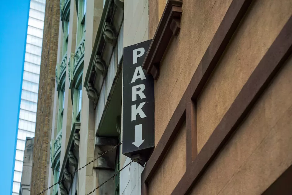 Close-up of vertical PARK sign on multistory urban parking garage.